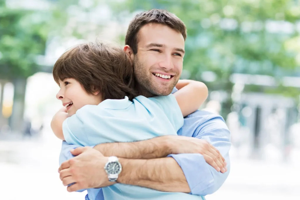 A father and child sharing a hug outside